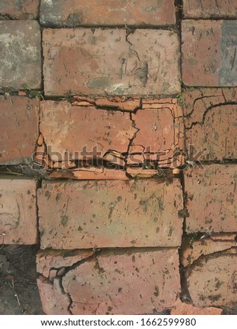 Cracked brick, top view, close-up. Brickwork on the ground.