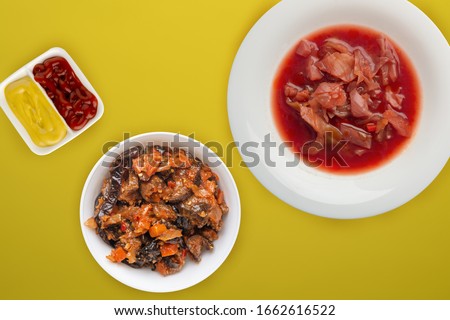 vegetable soup in a white plate on a yellow background. vegetarian healthy lunch