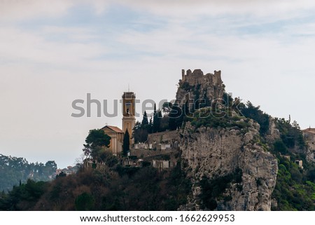 The close-up view of a medieval fortified castle of an old French village named Èze on top of a cliff in the Alps mountains (Côte d'Azur)