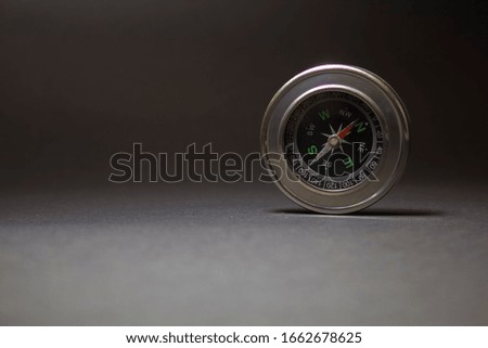 

A BEAUTIFUL COMPASS FOR TRAVELING ON A BLACK BACKGROUND