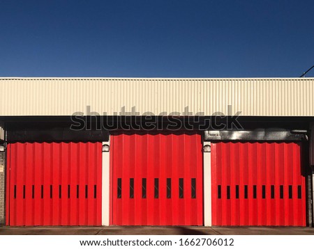 A bright red door to a fire station in Forest Hill, located in Southeast London.  Image has copy space.