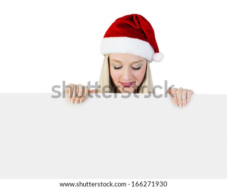 Beautiful Young Woman In a Santa Claus Costume holding a Signboard, looking at your text!