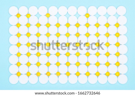 Background of white and yellow drugs close-up.Top view of fish oil for good health on a white background from pills. Concept of healthy eating.