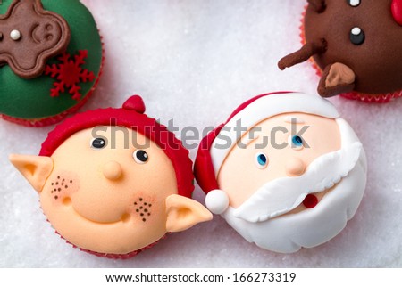 Christmas cupcakes with Santa Claus and Santa helper  