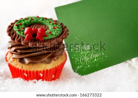 Christmas cupcake with blank card in snow