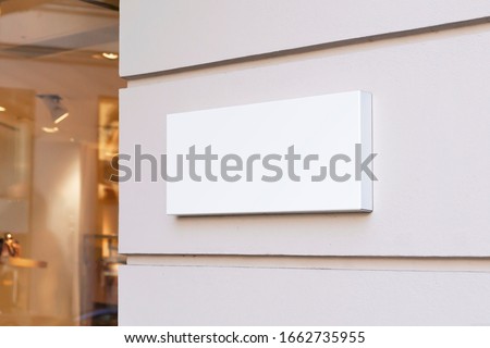 Blank store signage sign design mockup isolated, Clear shop template. Street hanging mounted on the wall. Signboard for logo presentation. Metal cafe restaurant bar plastic badge black white.  Royalty-Free Stock Photo #1662735955