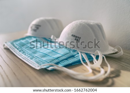 Corona virus prevetion face mask protection N95 masks and medical surgical masks at home . Royalty-Free Stock Photo #1662762004
