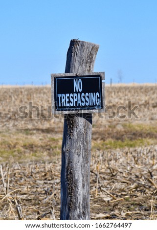 No trespassing sign on a fence post