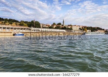 Panorama of Belgrade, Serbia, viewed from Sava river perspective, with Kalemegdan park, St. Michael's Cathedral bell tower, Tourist port, and downtown skyline. 