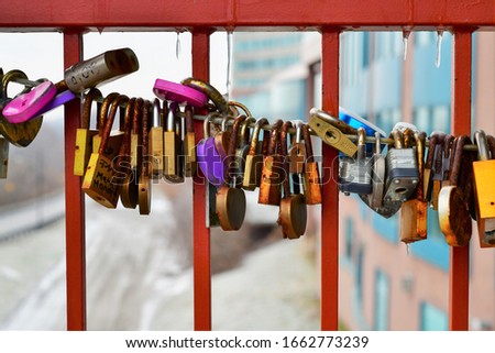 A bunch of locks on a bridge rail