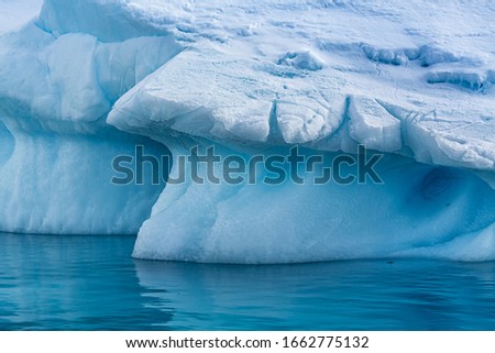 Large iceberg broken off of glacier floats near Antarctica