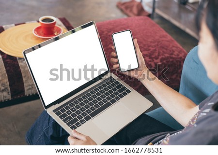 computer,cell phone mockup image blank screen with white background for advertising text,hand woman using laptop texting mobile contact business search information on desk in cafe.marketing,design