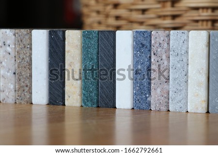 View of color samples stone  on oak wood table, Acrylic Solid Surface Royalty-Free Stock Photo #1662792661