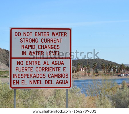 Rapid Changes in Water Level and Do Not Enter the Water sign overlooking the Colorado River in Laughlin, Clark County, Nevada USA