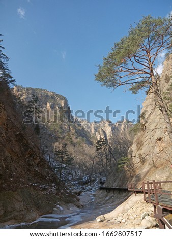 Winter scenery with hiking trail, gorge and mountain river with big boulders, Hiking in Seoraksan National Park