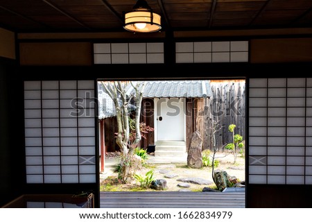 View of the garden from the inside of an old Japanese house with shoji paper sliding doors