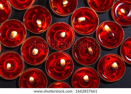 Candles burning on a black background