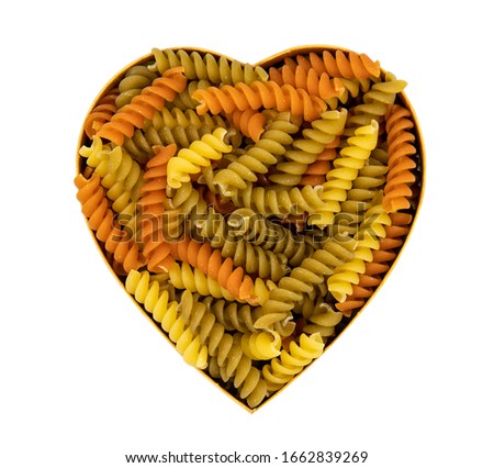 Colorful pasta in a heart shape isolated on white background. Valentines Day, Selective focus.