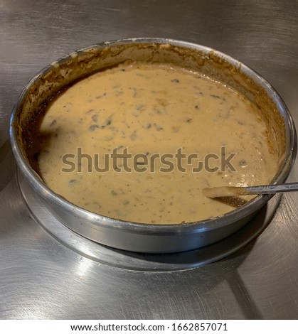 Cream of mushroom soup in soup warmer.