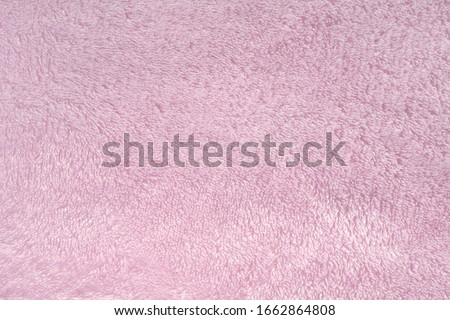 Fluffy pink synthetic fabric background. Soft plush pastel textile texture of winter clothing, baby toys, and home textiles. Rose delicate towel terry cloth. Plush fabric cozy plaid Royalty-Free Stock Photo #1662864808