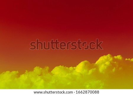bright yellow green clouds in deep red sky