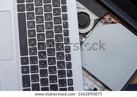 Repair and maintenance laptop computer with Thai keyboard. Royalty-Free Stock Photo #1662890875