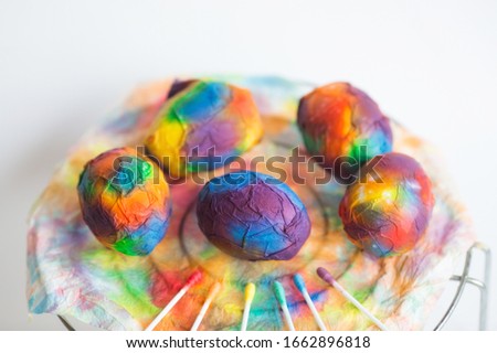 Bright, multi-colored Easter eggs on a colorful background. Minimal concept. Card with copy space for text.