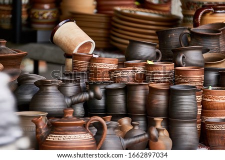 Rustic handmade ceramic clay brown terracotta cups souvenirs at street handicraft market