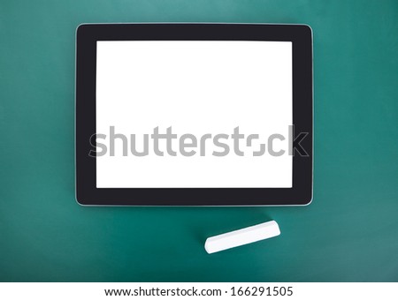High Angle View Of Digital Tablet On Chalkboard
