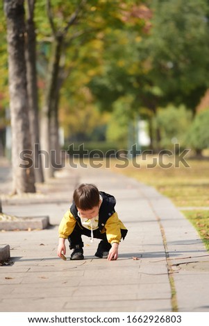 Children squatting on the side of the road playing