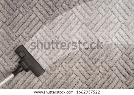 Carpet cleaning with vacuum cleaner. Housekeeping concept. Royalty-Free Stock Photo #1662937522