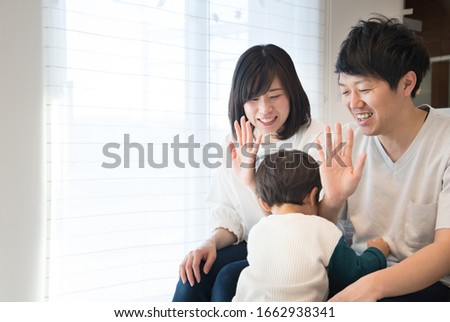 A couple having a high five with a child