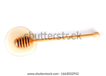 Honey and honey dipper on white background