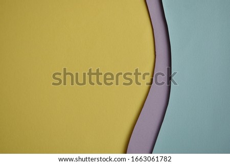 flat lay of pastel paper color, yellow and blue, in layer of line and curves