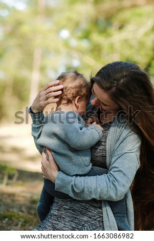 happy family photo. mom and little girl are having fun. great family happiness. mom without makeup. natural feminine beauty. girl with very long hair. mother's tenderness to the baby