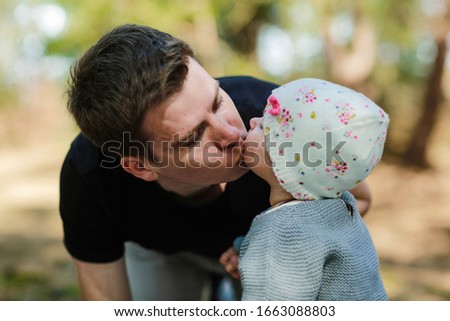 dad kisses his little daughter. Dad's tenderness to the baby