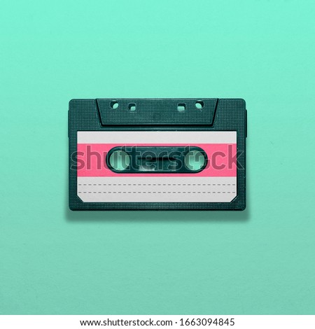 Retro audio cassette isolated on blue background, pop art design, close up Royalty-Free Stock Photo #1663094845