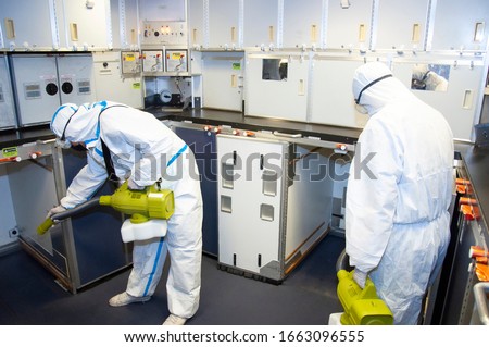 Aircraft interior cabin deep cleaning for Coronavirus (Covid-19) disease prevention. Royalty-Free Stock Photo #1663096555
