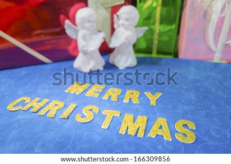 Golden Christmas word on blue fabric  with decoration