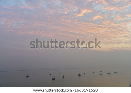 Large number of traditional fishing boat on Lake Tai (or Lake Taihu) one of the largest freshwater lakes in China during sun set and beautiful colored sky

