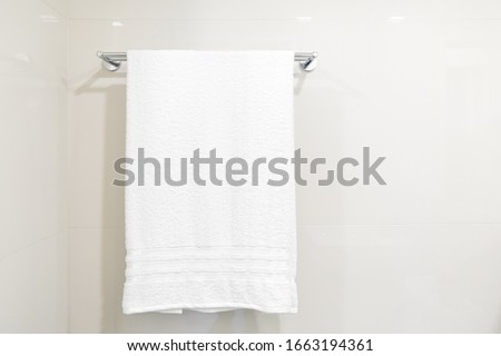 Closeup white  towel hanging on clothesline in the bathroom with space for texts