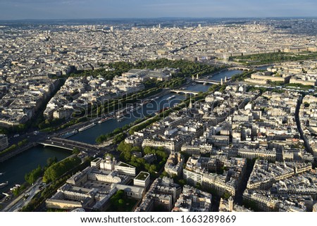 Panoramic aerial view of Paris from the top of the Eiffel Tower - Outstanding view and landscape in a beautiful sunny day before the sunset - France, Europe