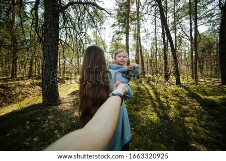 family photo in the forest. very long hair mom and little daughter. happy family photo in the forest. young, beautiful parents. family idyll