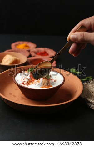 Indian Snack known as Dahi vada (Fried balls with curd) is a very famous Holi Snack in india, served in Earthen platter with different varieties o