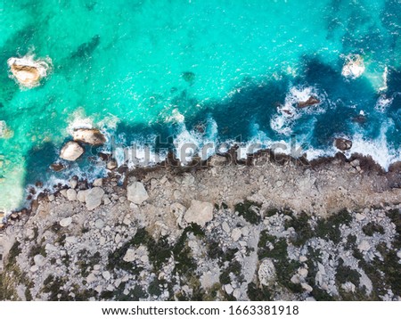 Drone, Bird's Eye, Aerial Top-Down View of a rocky shore with blue water crushing on it. Cap de Formentor, Palma de Mallorca, Balearic Islands, Spain