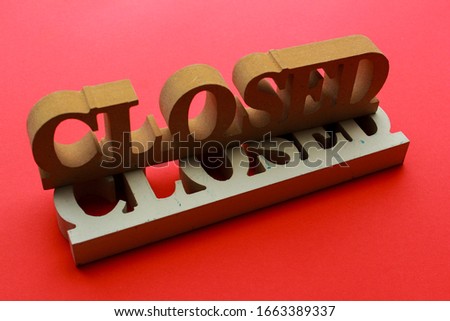 "closed" wooden sign. red background. sign board.