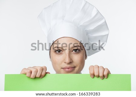 Beautiful chef looking over paper