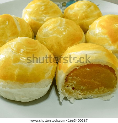 Picture of Round ball rice cake Yellow, white, inside with bean filling Chinese Lunar New Year Dessert