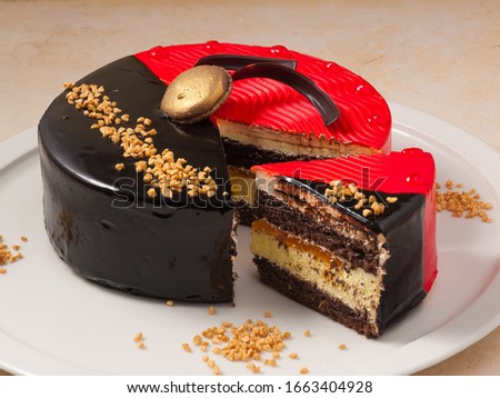 red and black chocolate cake with nuts and sponge cakes