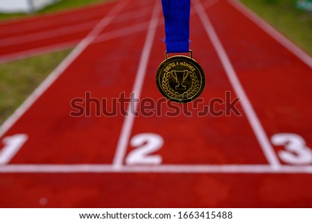 Sport motivation photo, golden medal with trophy and Tittle. You Are a Winner